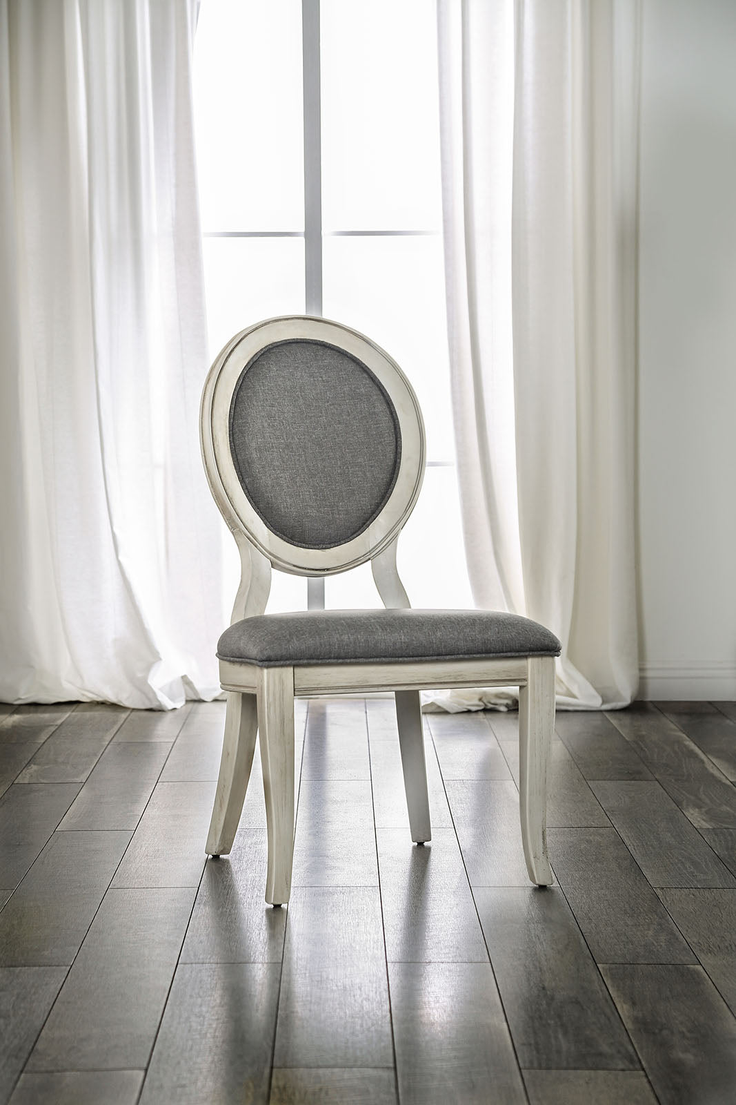 Elegant ovalback dining chair with grey upholstered seat and distressed white frame