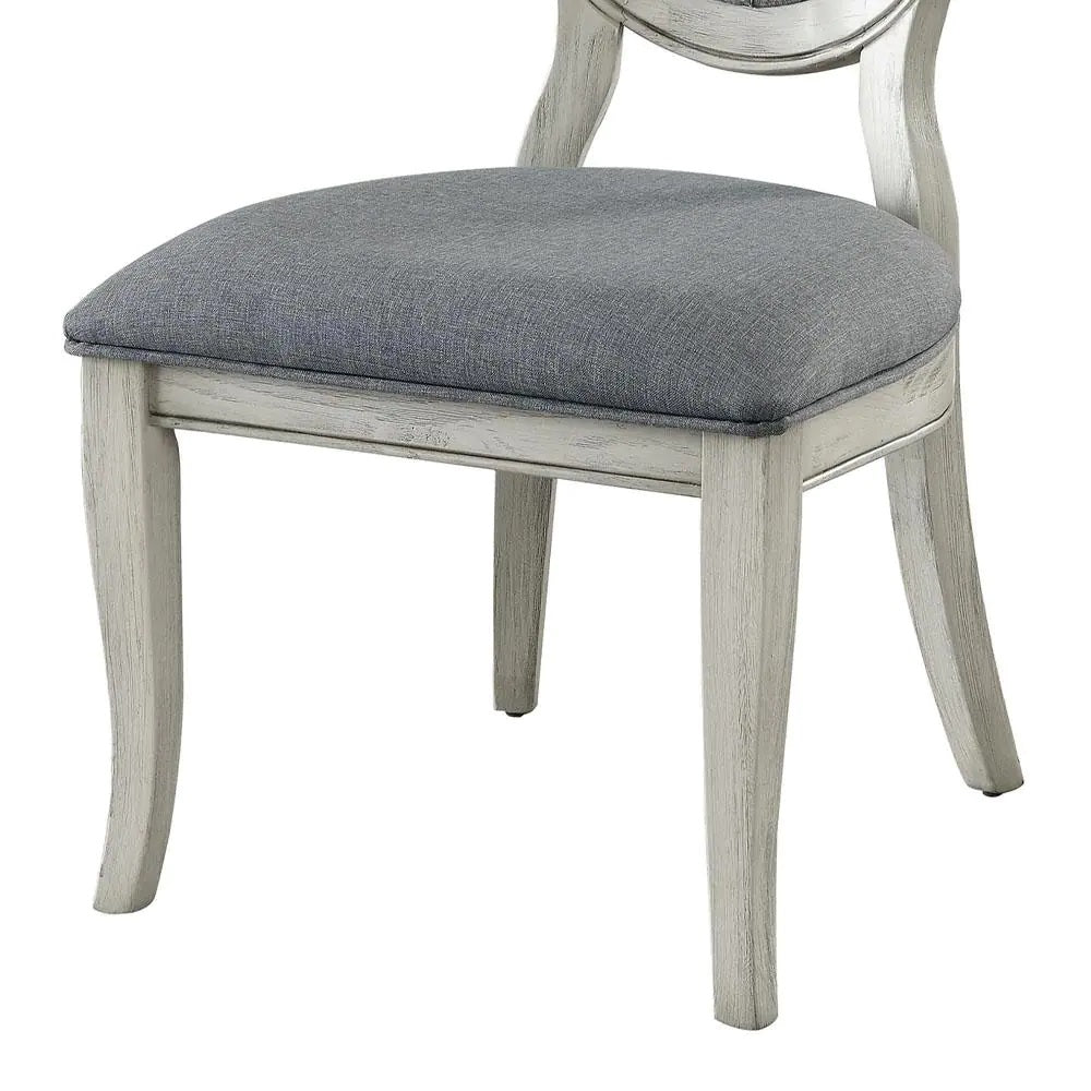Distressed white wood dining chair with gray upholstered seat