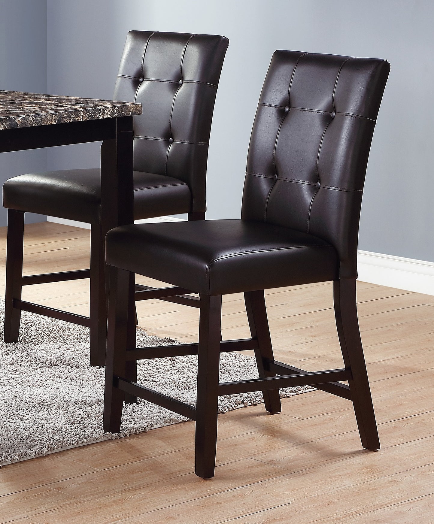 Dark brown faux leather tufted bar stool with wooden legs perfect for kitchen islands