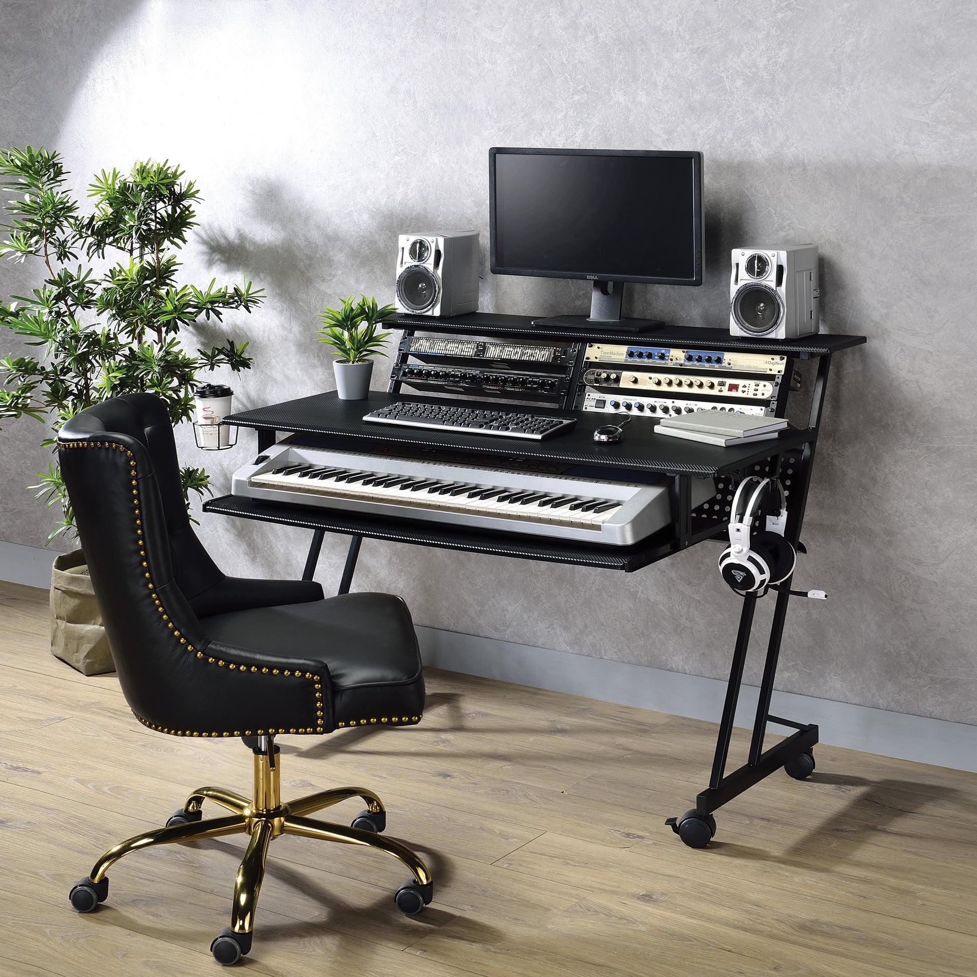 Black leather studio chair with gold accents and casters