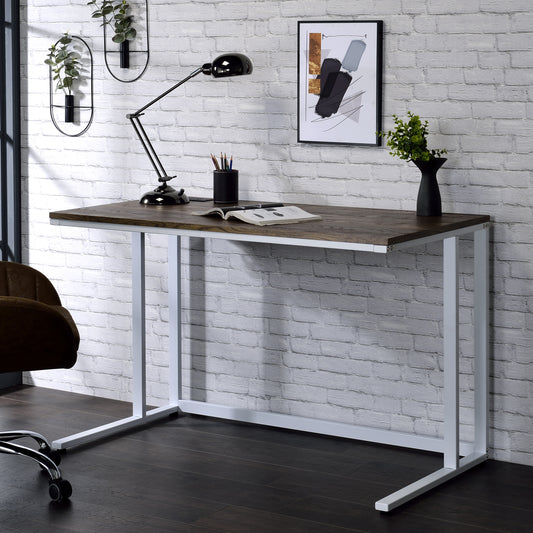 Dark wood and white metal desk with open magazine and black desk lamp