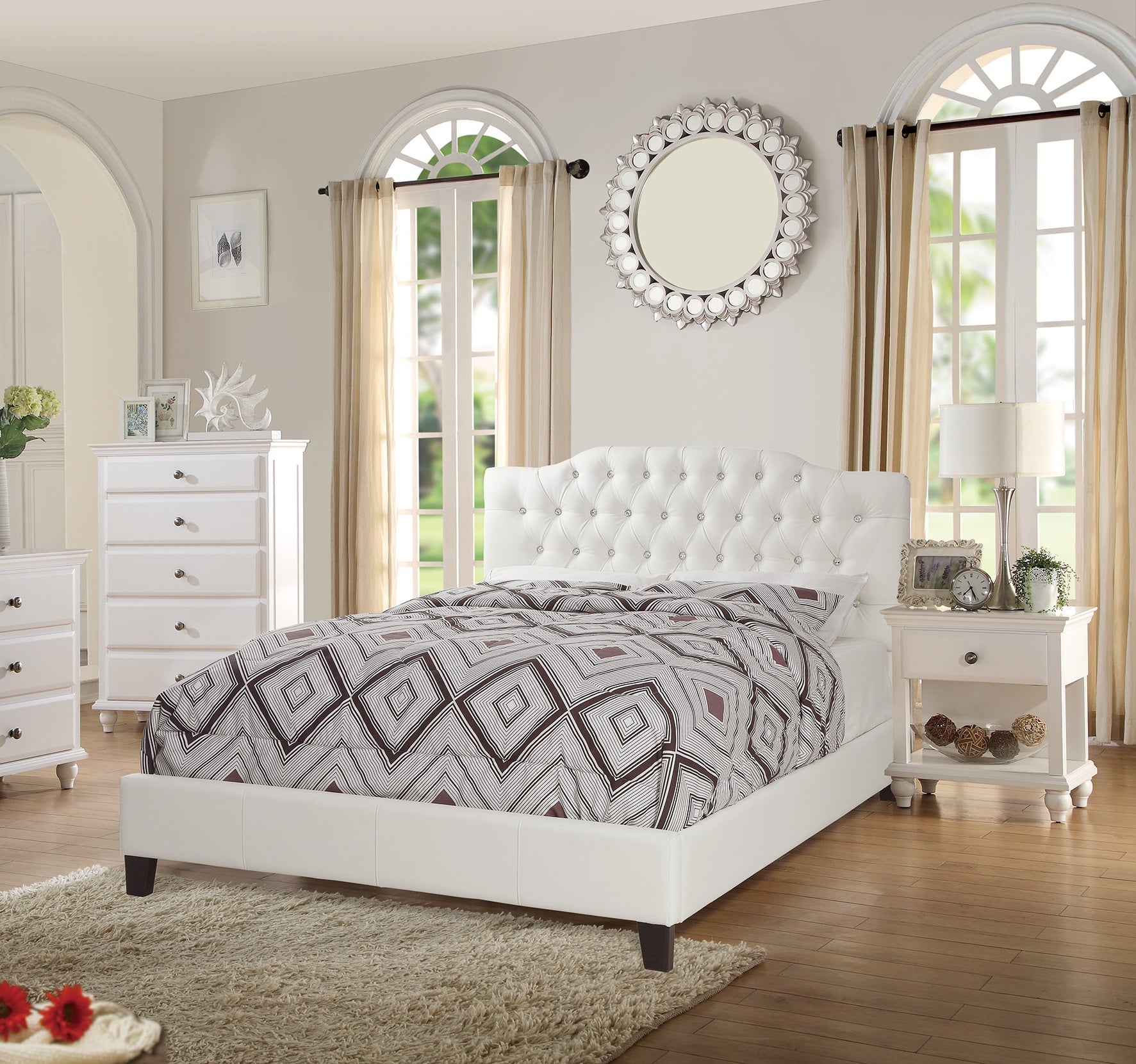 White tufted queen bed with crystal accents and diamond pattern bedding