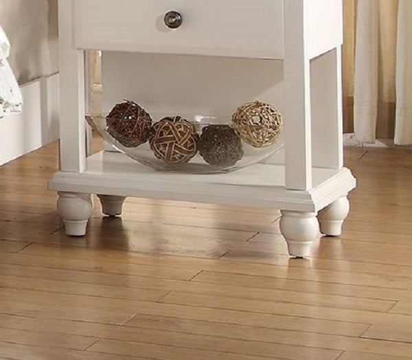 White wooden nightstand with woven decorative balls in a glass bowl