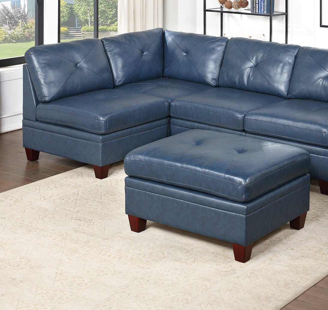 Deep blue leather sectional sofa with tufted cushions and a matching ottoman