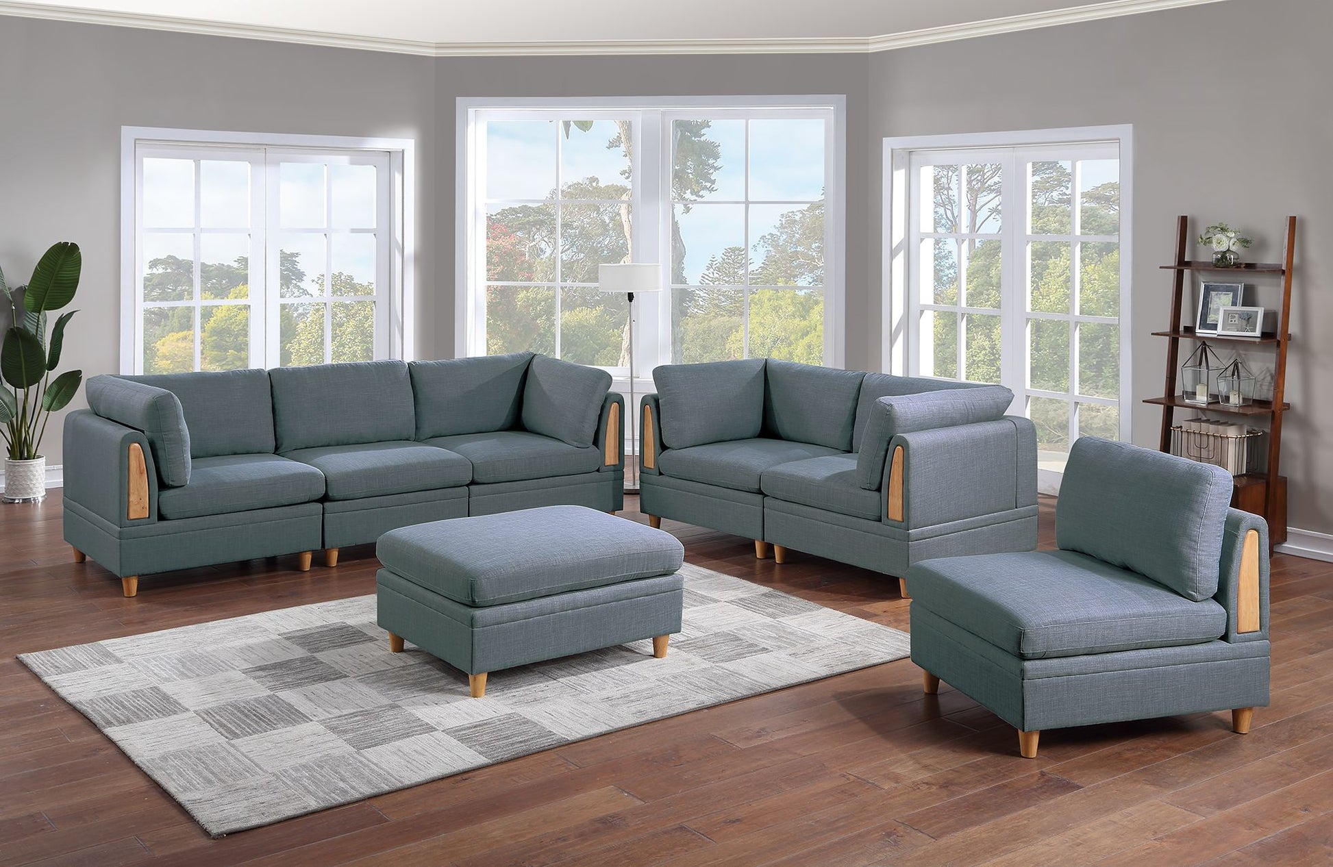 Gray fabric modular sectional sofa with wooden accents and matching ottoman on a checkered rug