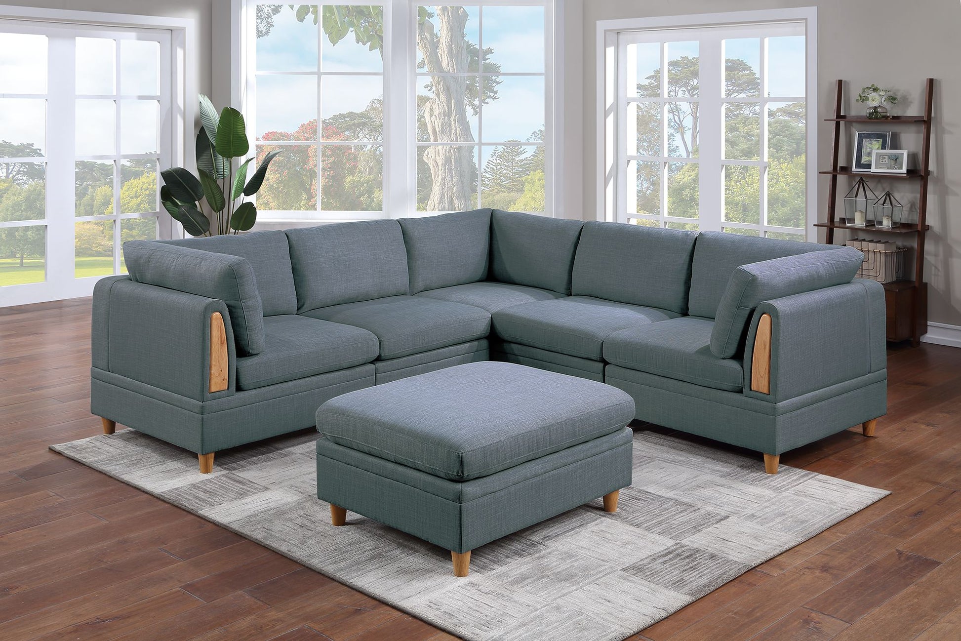 Gray fabric sectional sofa with wooden arm accents and matching ottoman