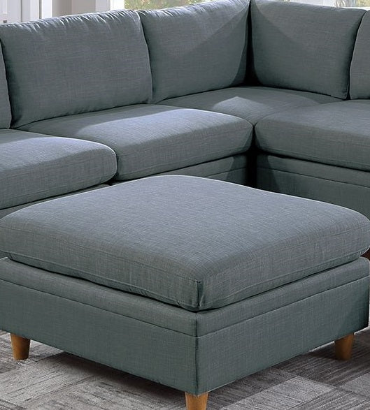 Gray linen sectional sofa with an ottoman featuring wooden legs for modern living spaces