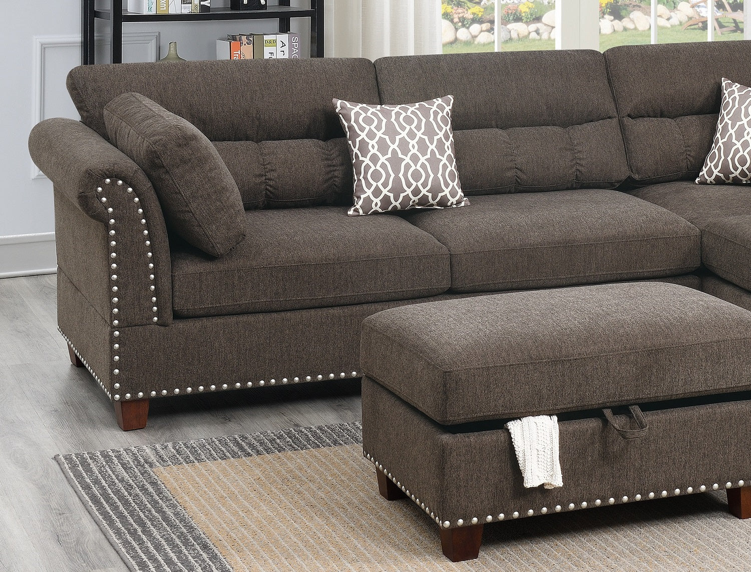 Brown fabric sectional sofa with decorative nailhead trim and throw pillows