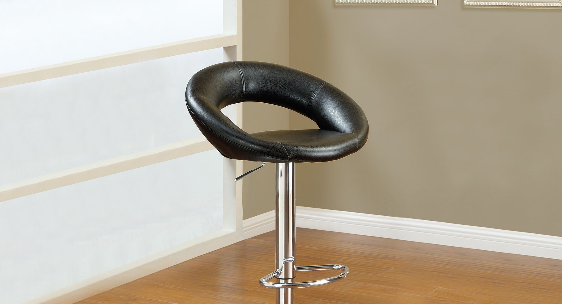 Black faux leather bar stool with a curved seat and chrome base