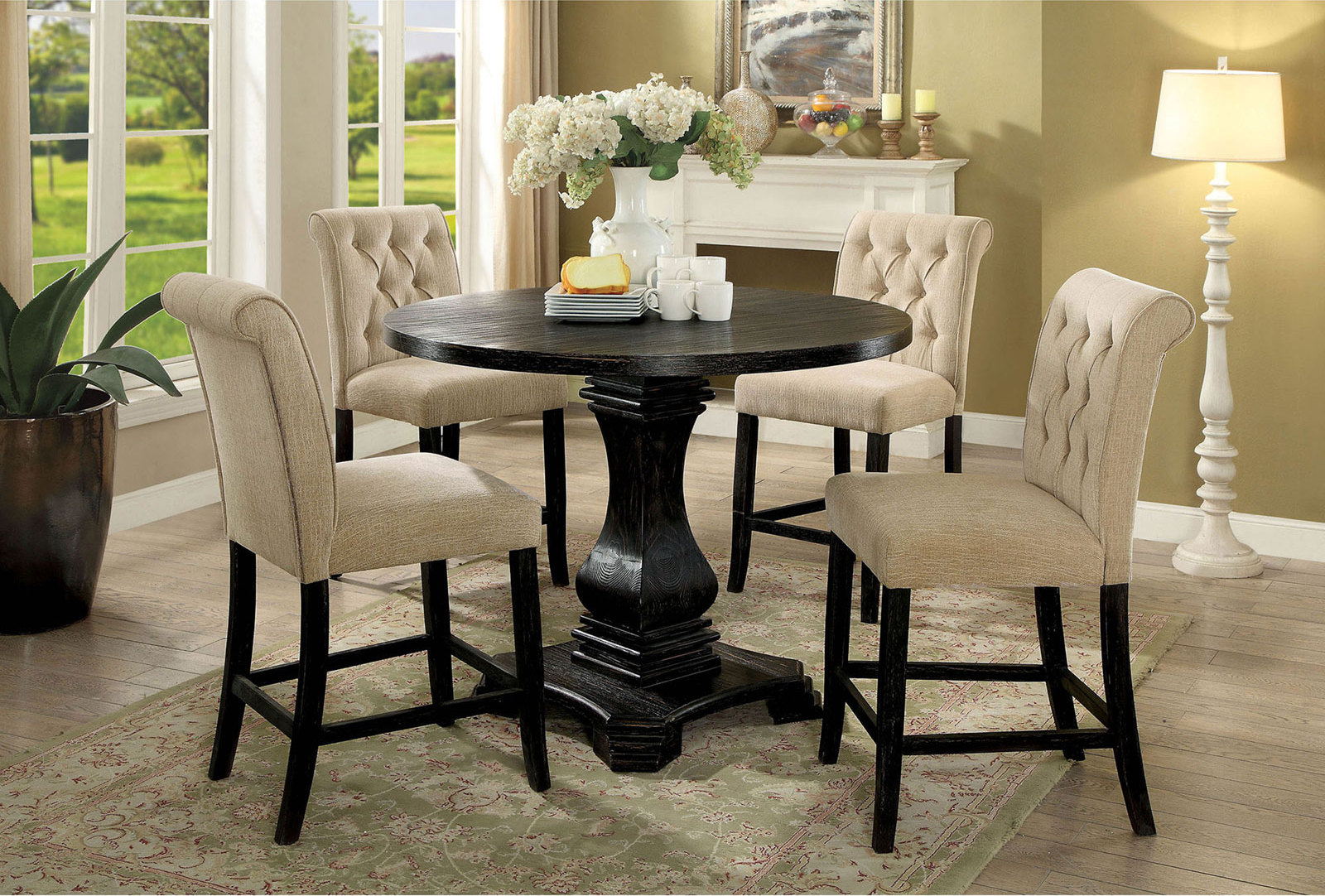 Dark wood round bar table with four tufted beige counter chairs