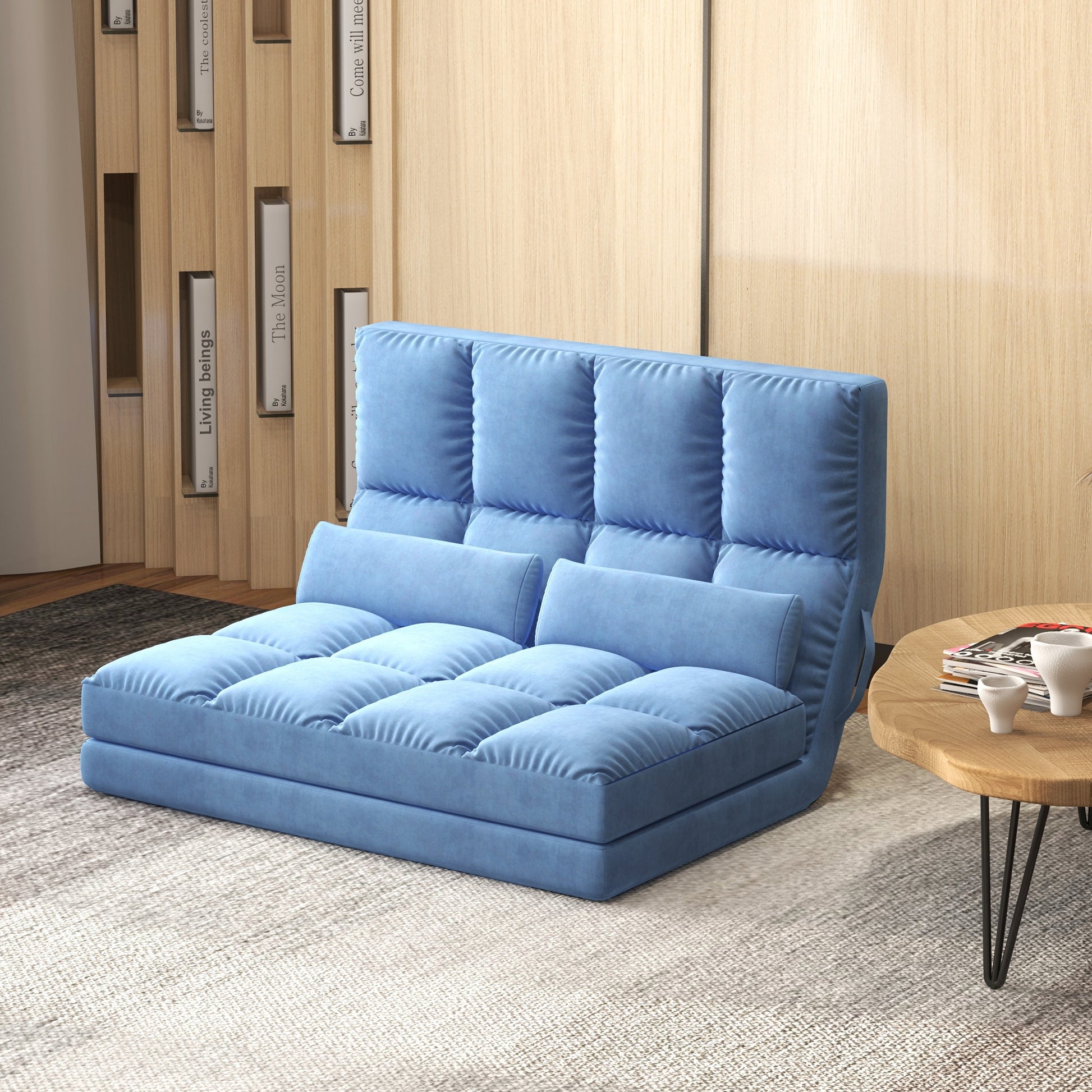 Blue upholstered convertible sofa bed with tufted cushions