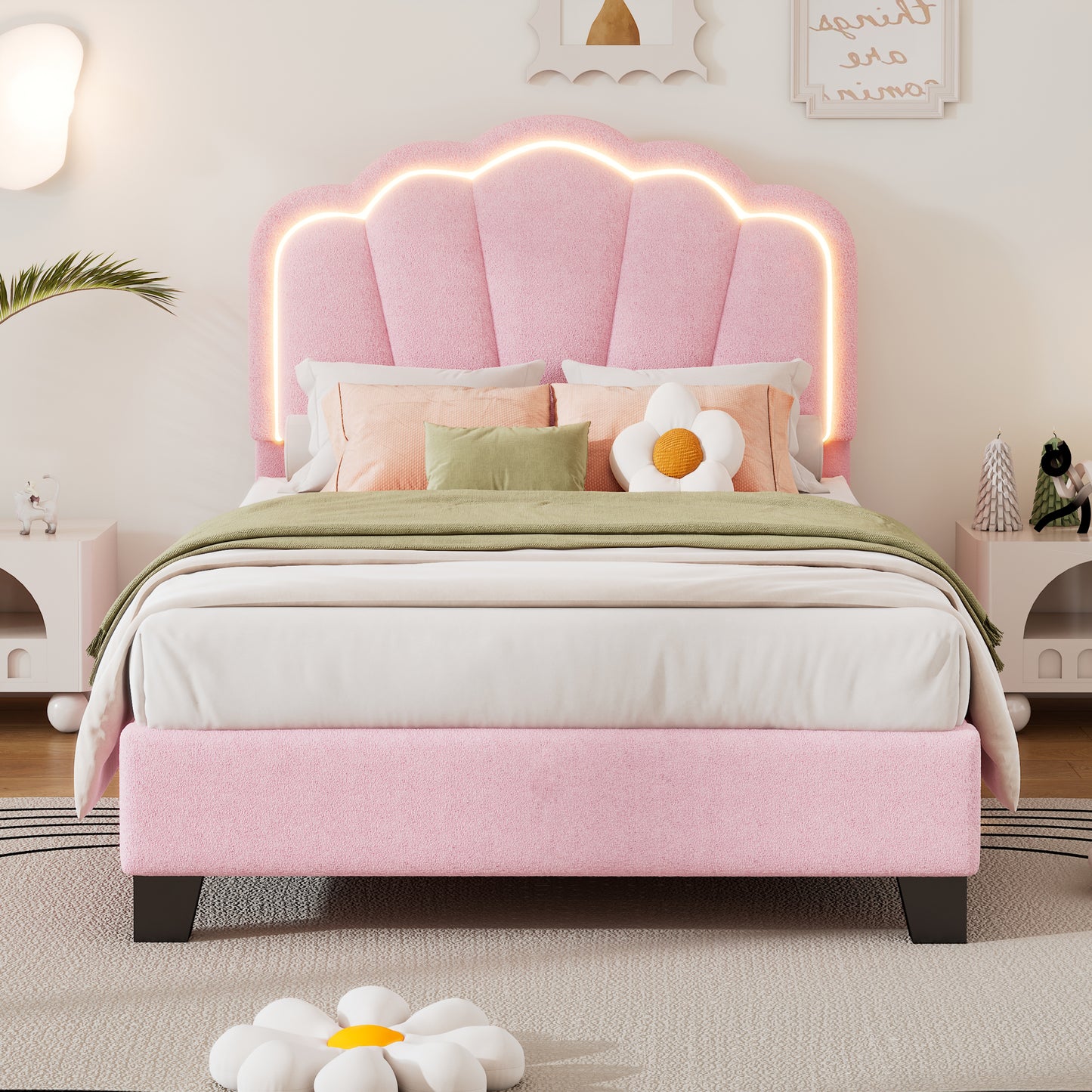 Pink upholstered twin bed with a shellshaped headboard and integrated neon light