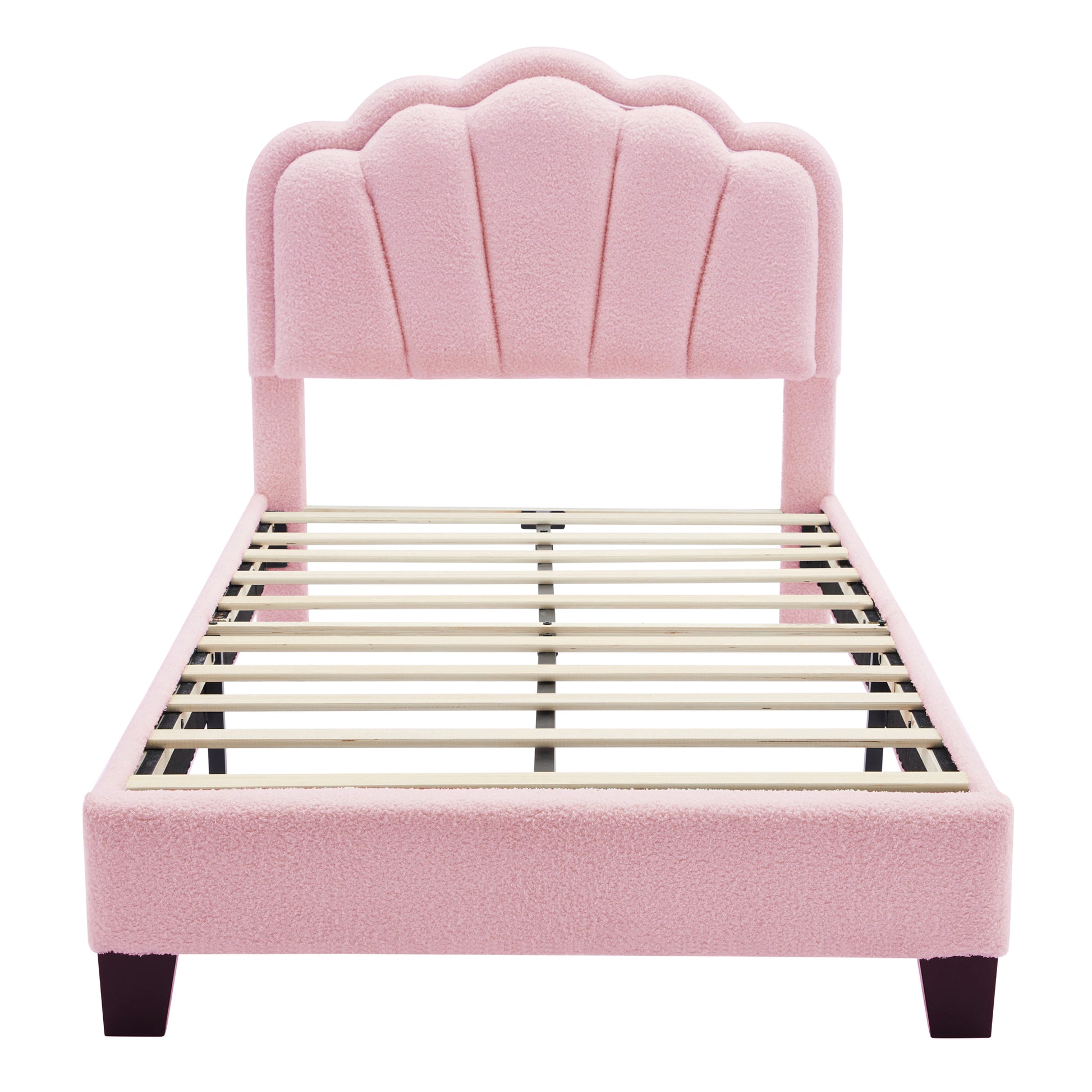 Pink boucle upholstered bed frame with a scalloped headboard and wooden slats