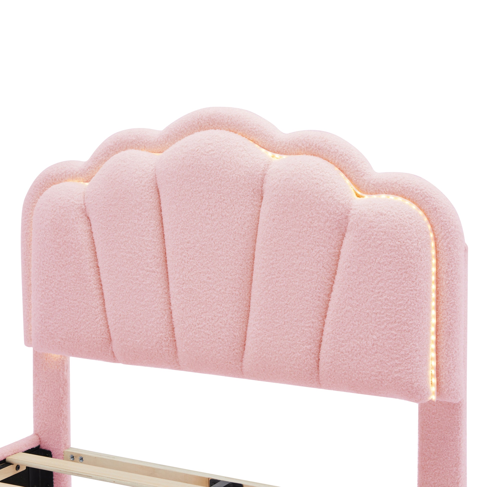 Pink sherpa upholstered headboard with shell design and builtin LED lights