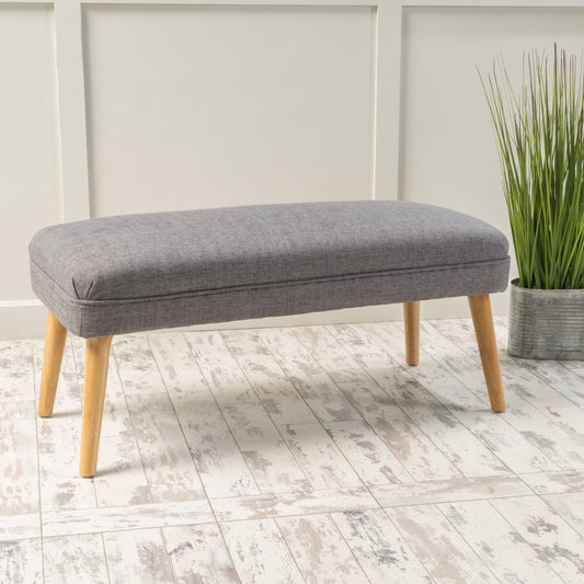 Gray fabric upholstered bench with tapered wooden legs perfect for entryways