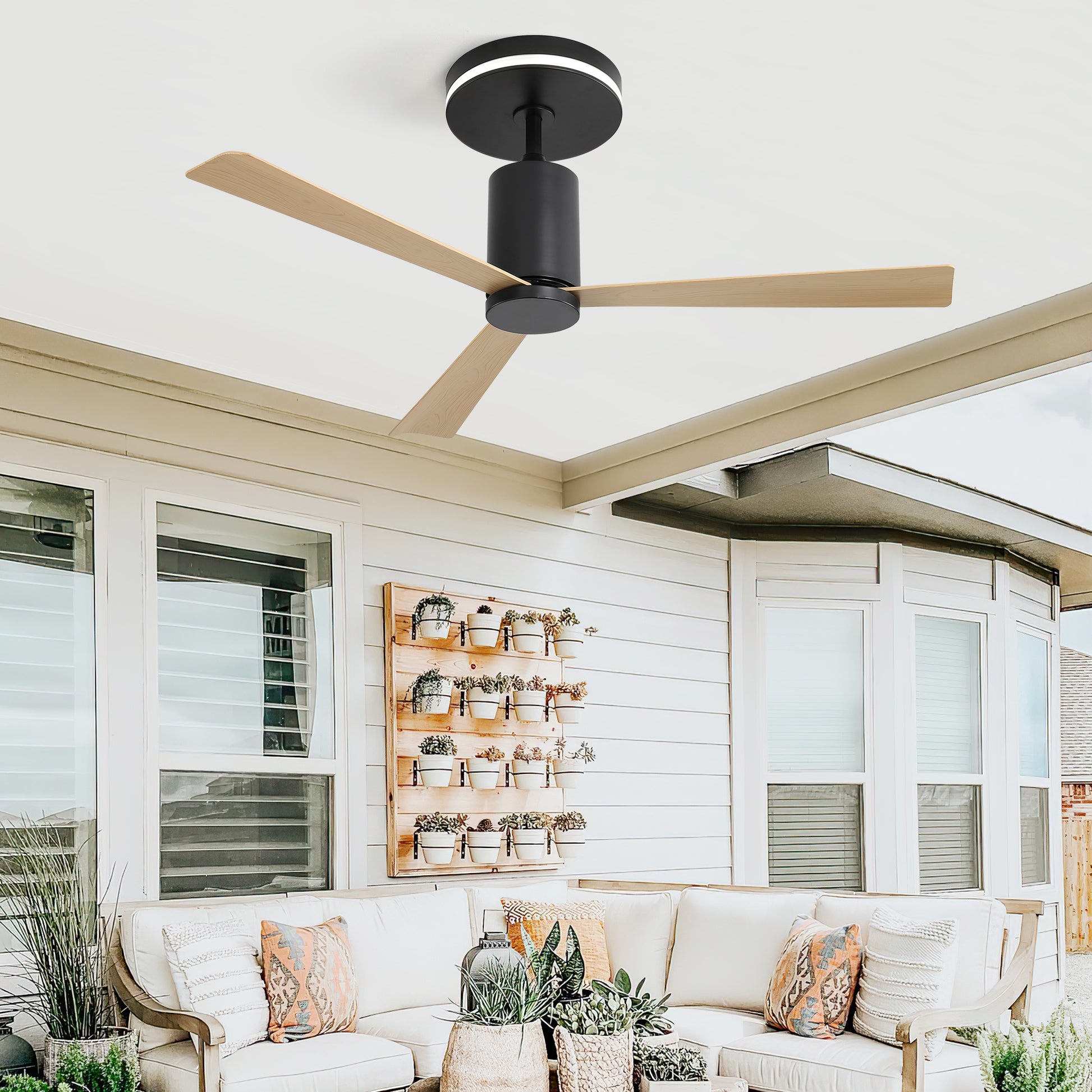 Black flush mount ceiling fan with integrated LED light and light wood blades for patio
