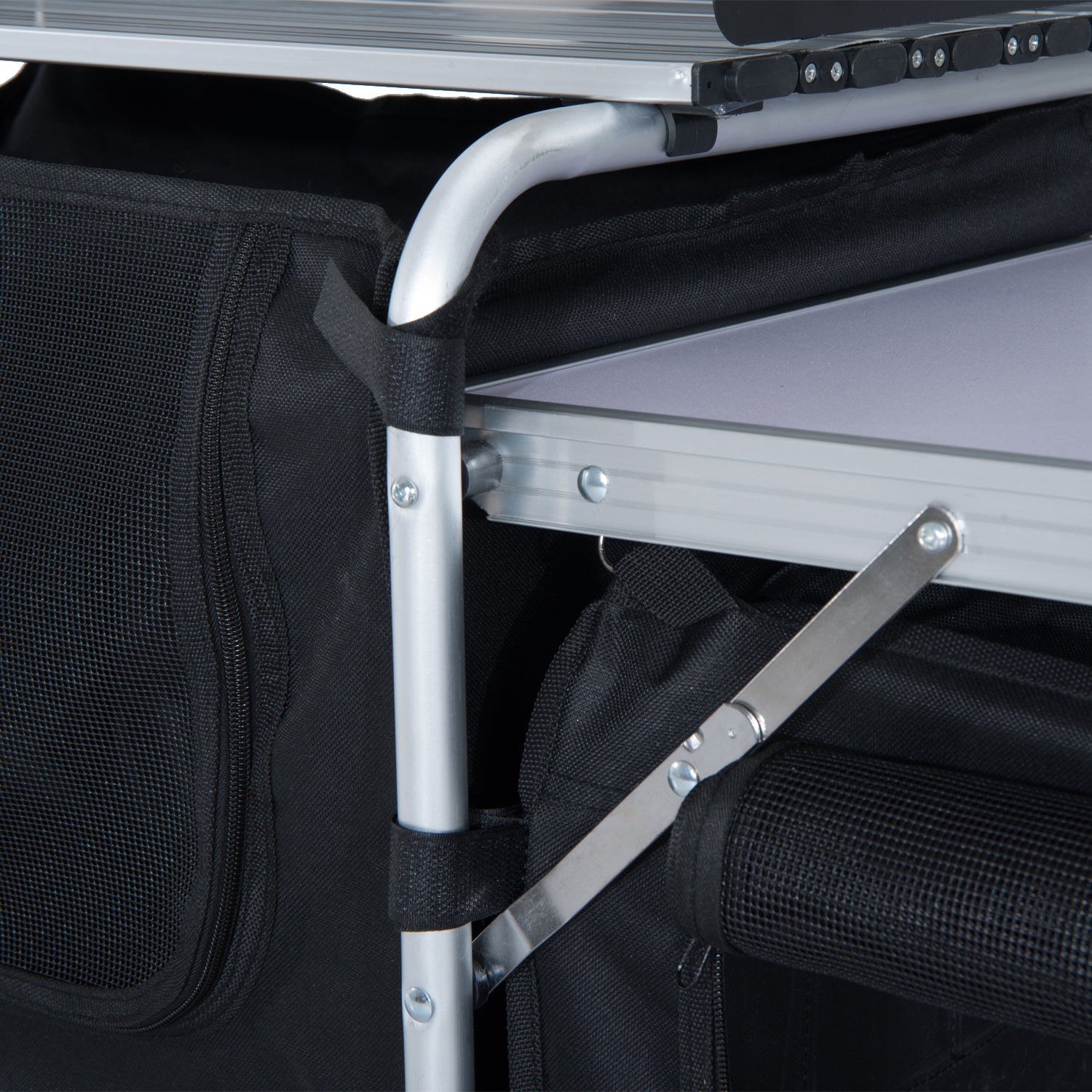 Detailed view of black fabric shelves on a portable camping table