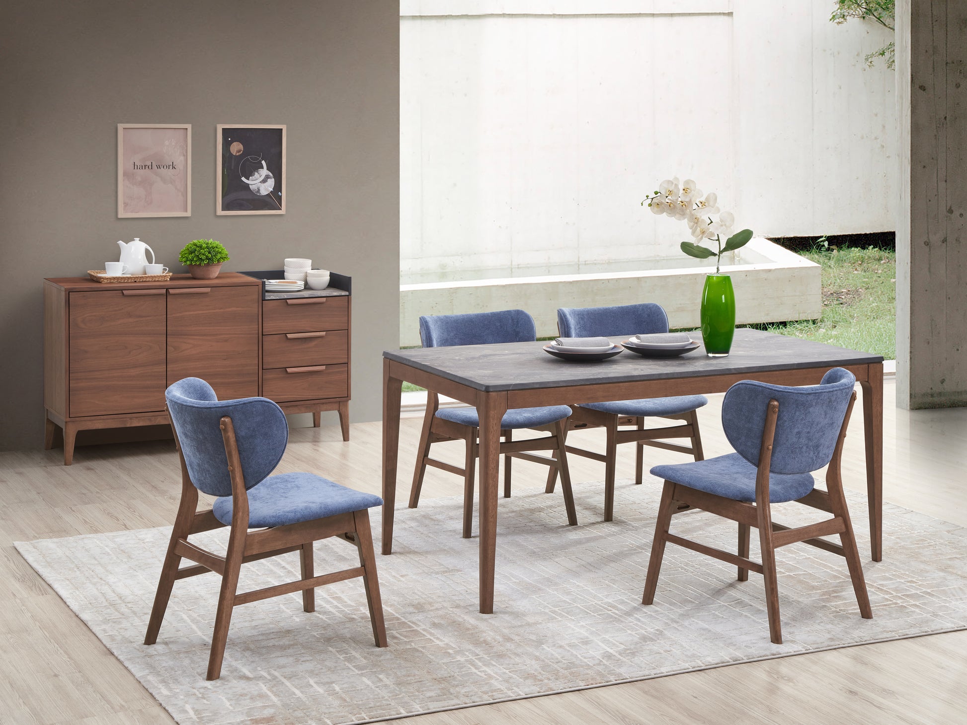 Wooden dining table with dark stone top and blue upholstered chairs