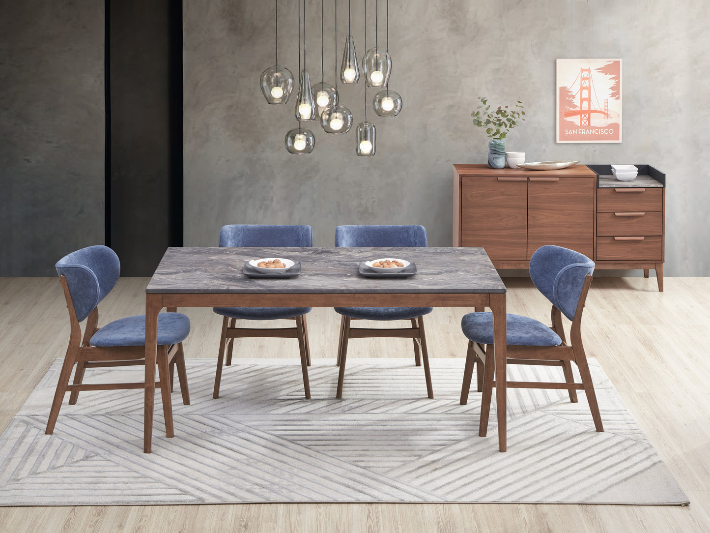 Gray marbled stone dining table with wooden legs seats four in blue upholstered chairs