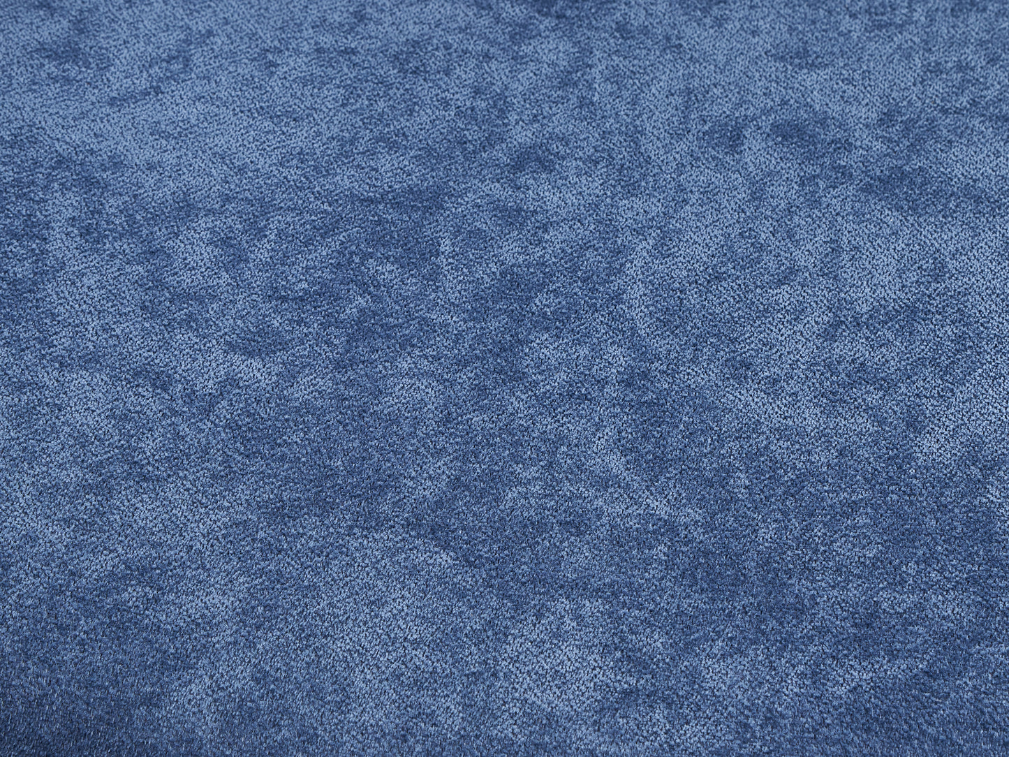 Closeup of textured denim fabric in a deep indigo blue shade