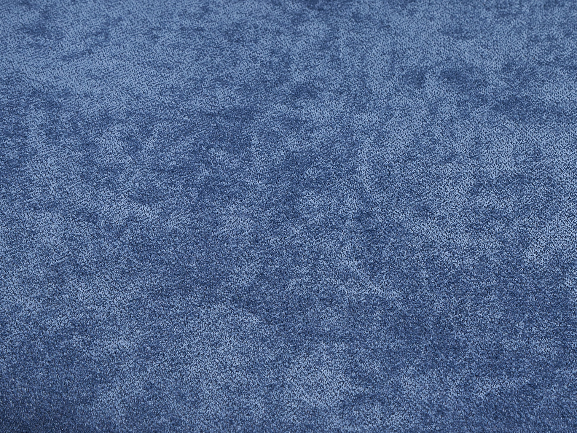 Closeup of textured denim fabric in a deep indigo blue shade