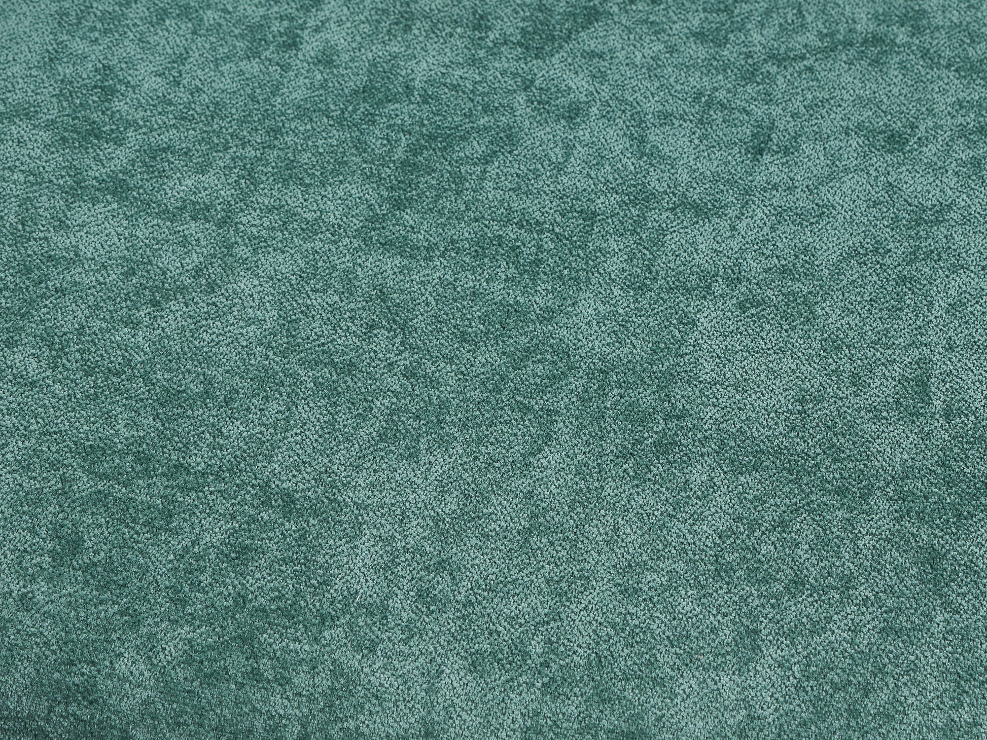 Closeup of soft teal velvet fabric ideal for upholstery projects