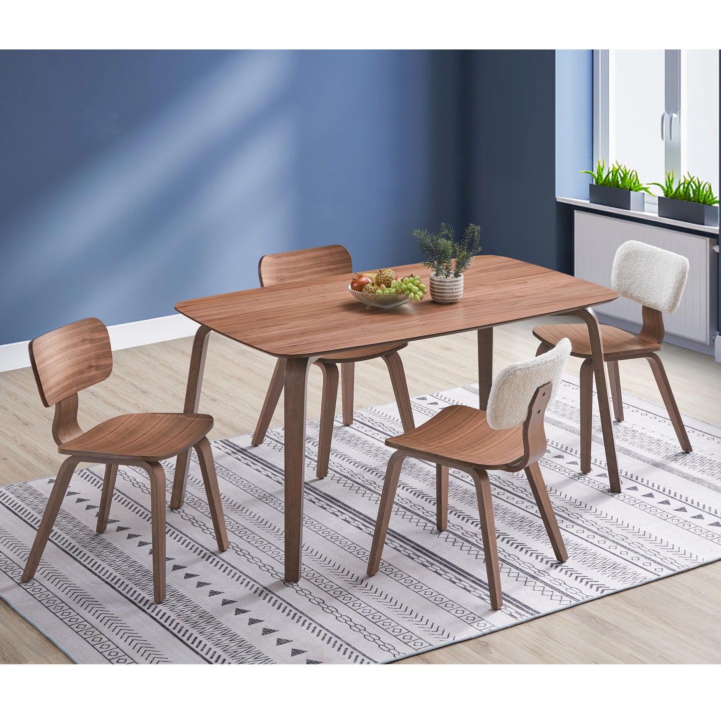 Wooden dining table with curved midcentury modern chairs perfect for small spaces