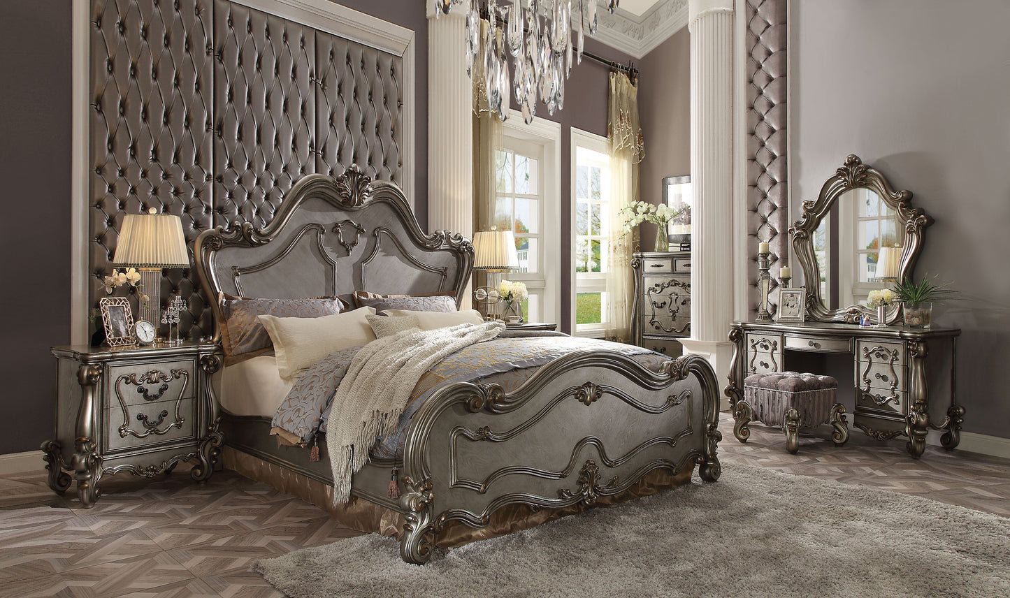 Ornate silver tufted headboard bed with plush bedding and decorative throw