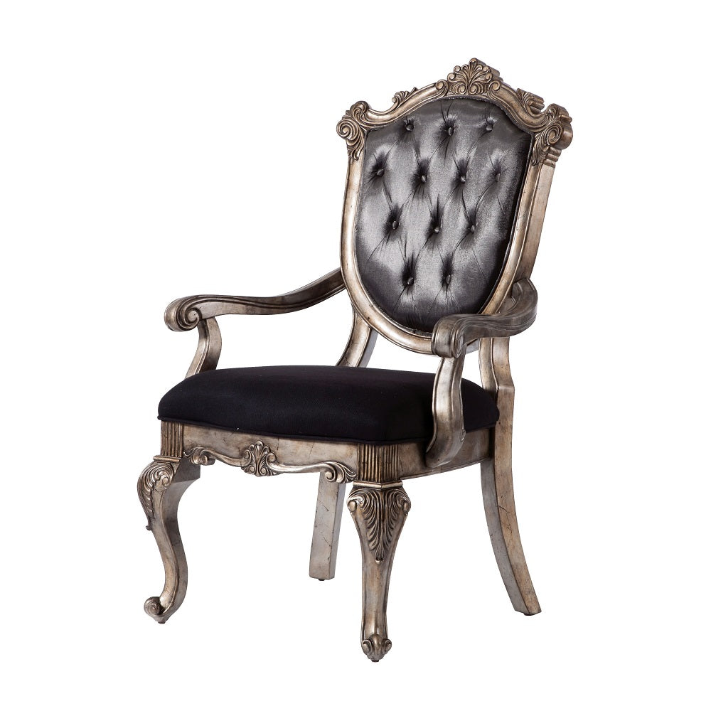 Ornate silver baroque armchair with black tufted seat and back