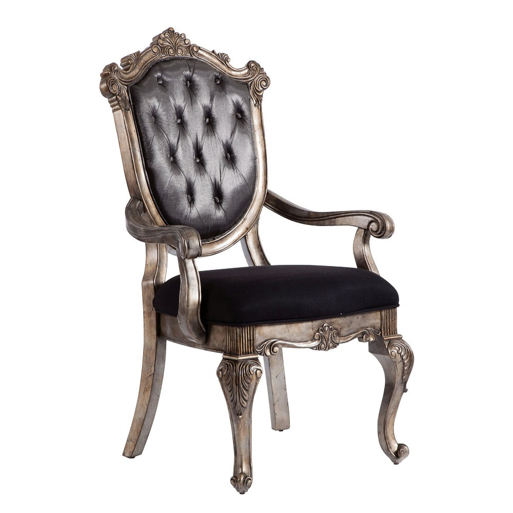 Ornate silver armchair with tufted black leather seat and back