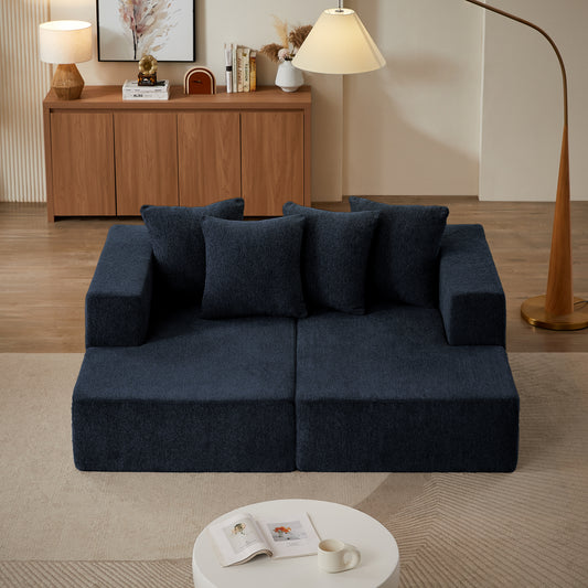 Navy blue modular sofa with plush fabric upholstery and four matching throw pillows