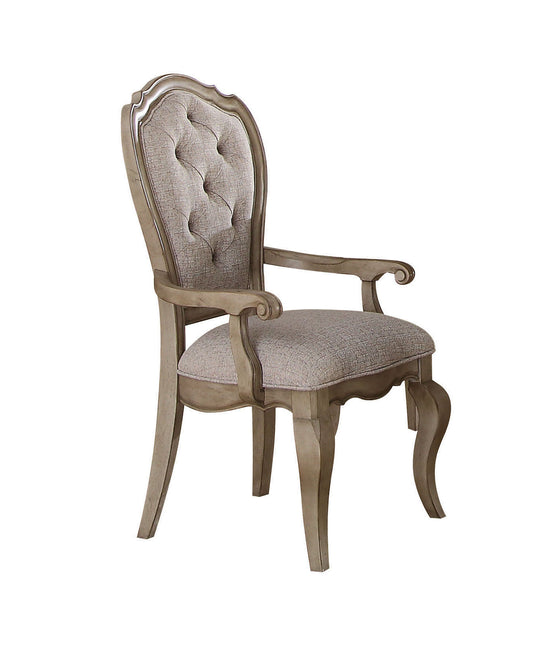 Tufted fabric upholstered dining chair with carved wooden frame in antique oak finish