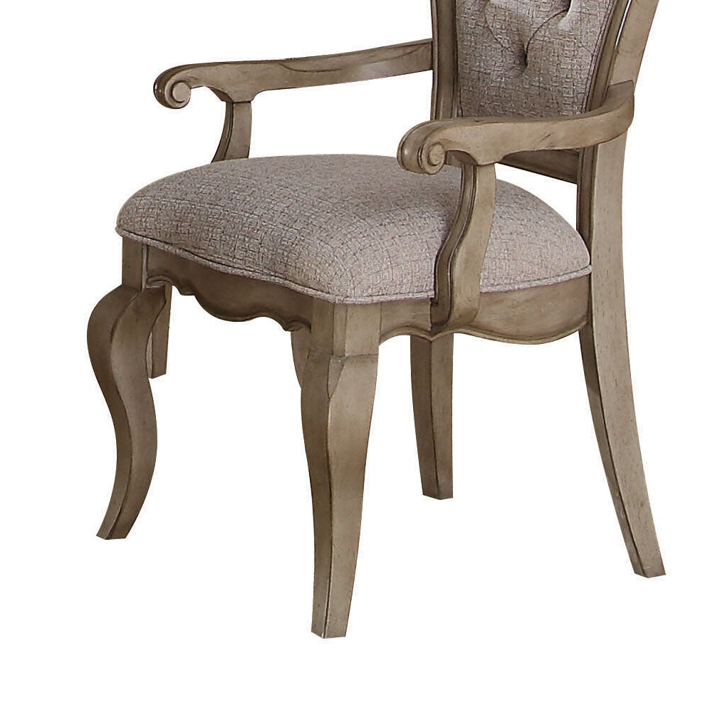 Ornate carved wood armchair with textured grey fabric seat and back