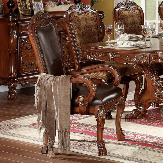 Ornate dark brown leather dining chair with carved wood accents and a draped throw