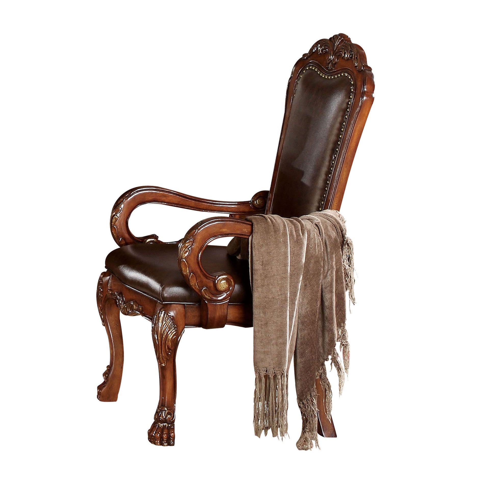 Ornate dark brown leather armchair with carved wood detailing and decorative nailheads