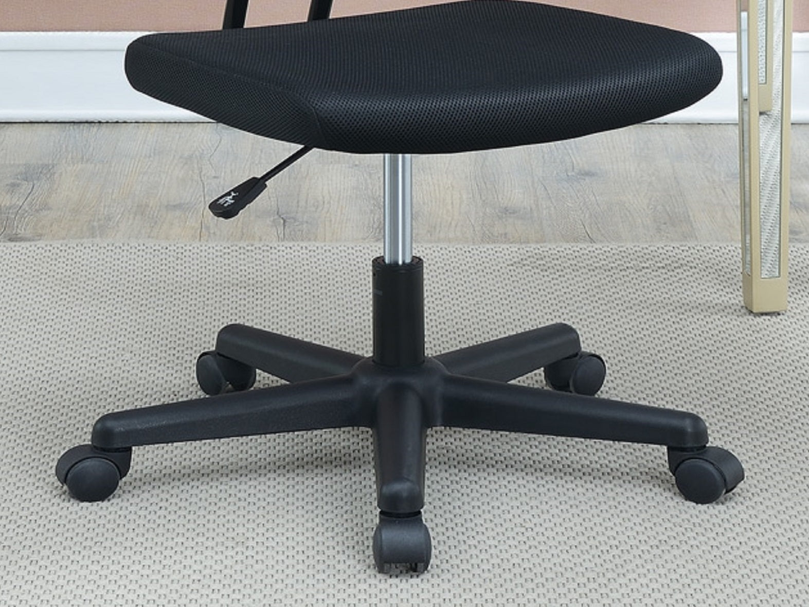 Black mesh office chair with a star base and wheels perfect for home workspaces