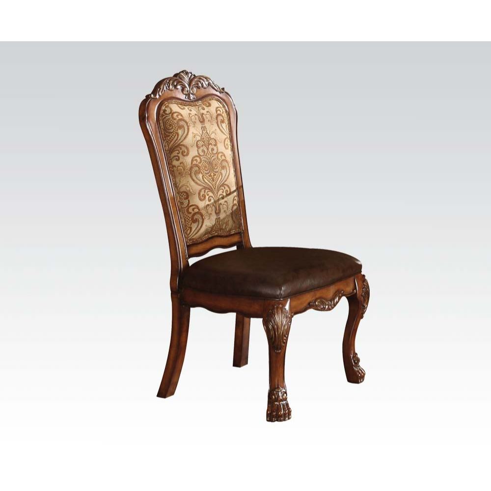 Ornate wooden dining chair with brown leather seat and patterned upholstered back