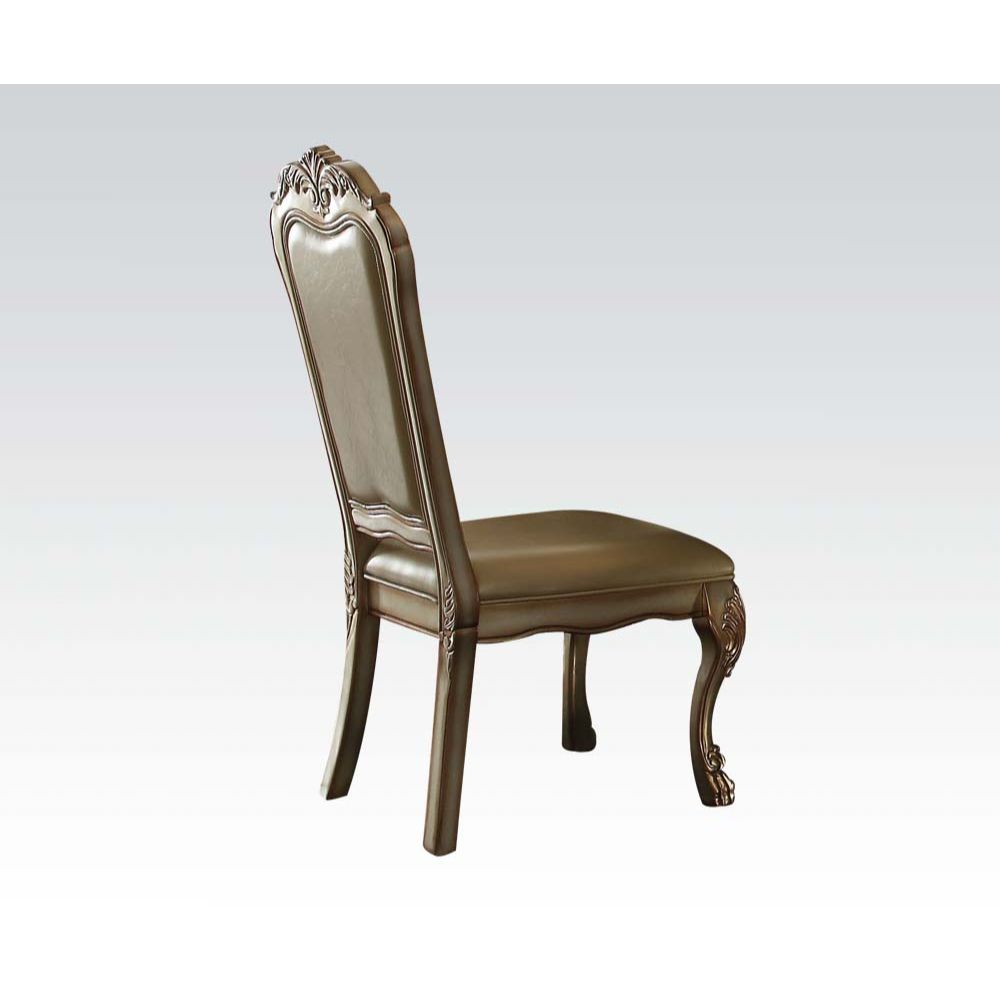 Ornate traditional dining chair with brown faux leather seat and carved wood frame