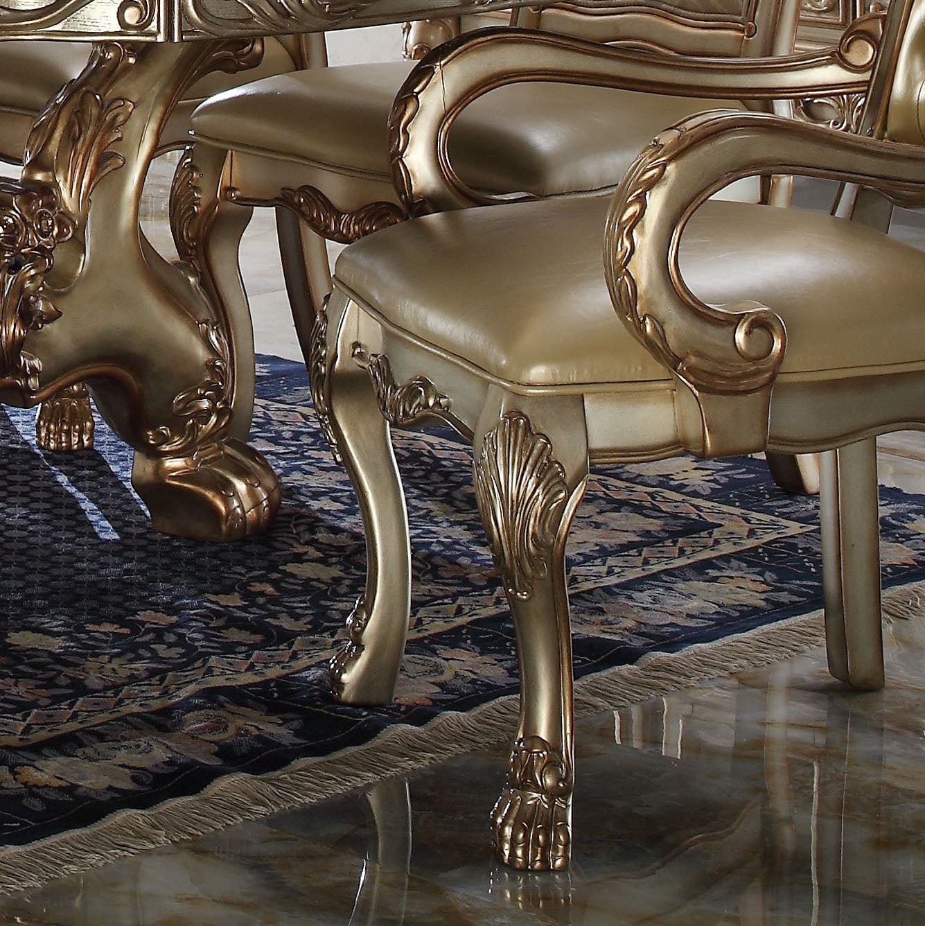 Ornate gold dining chair with upholstered seat and claw foot legs