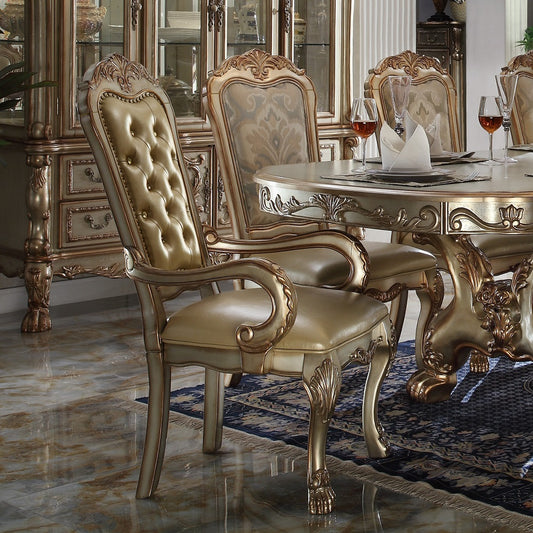 Tufted gold leather dining chair with ornate silver carved wood accents