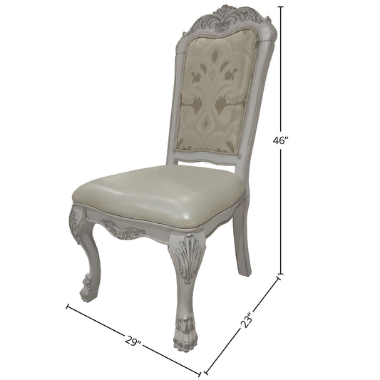 Ornate grey upholstered dining chair with ornate carving details and a damask pattern backrest