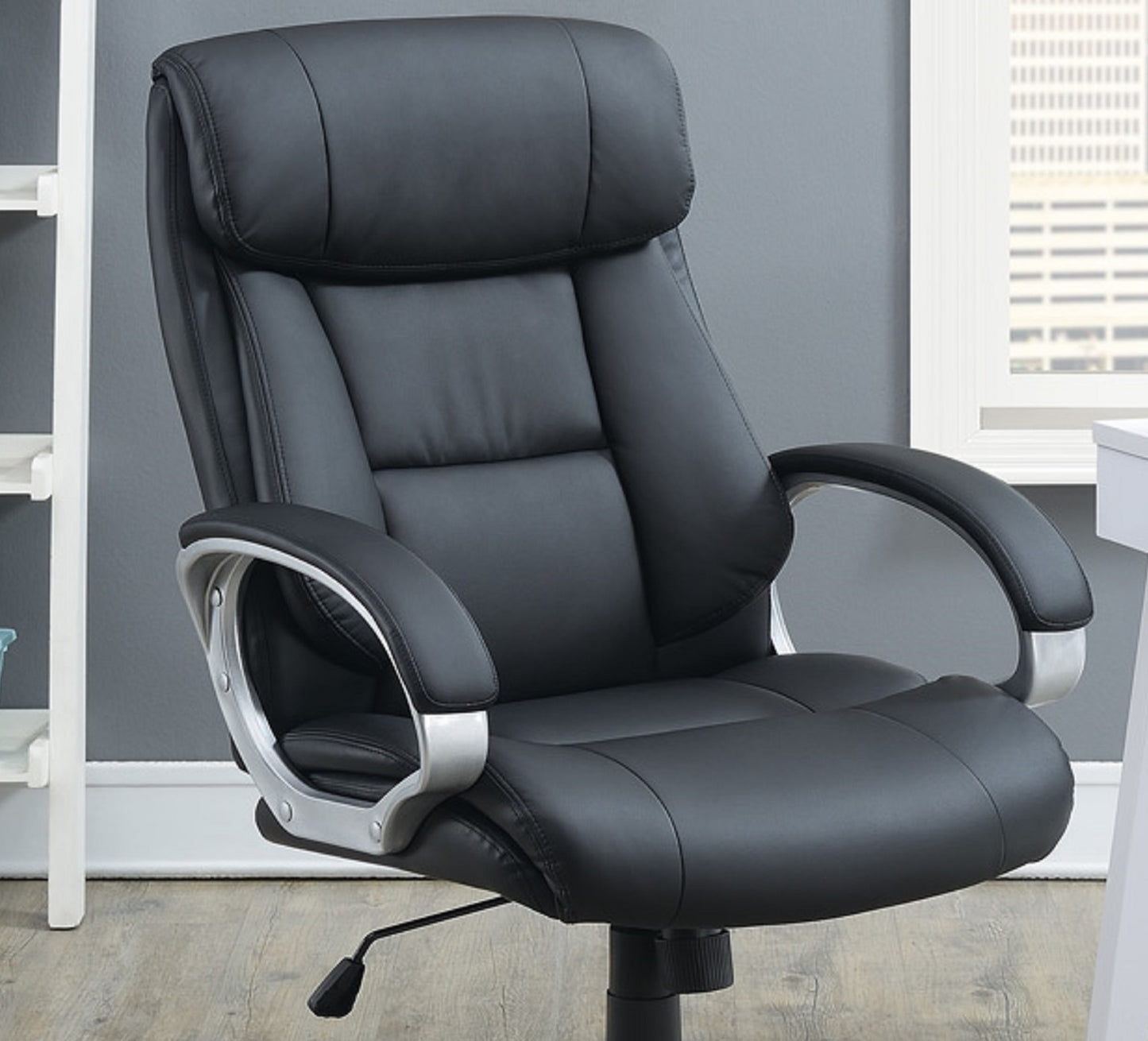 Black executive office chair with padded armrests and lumbar support