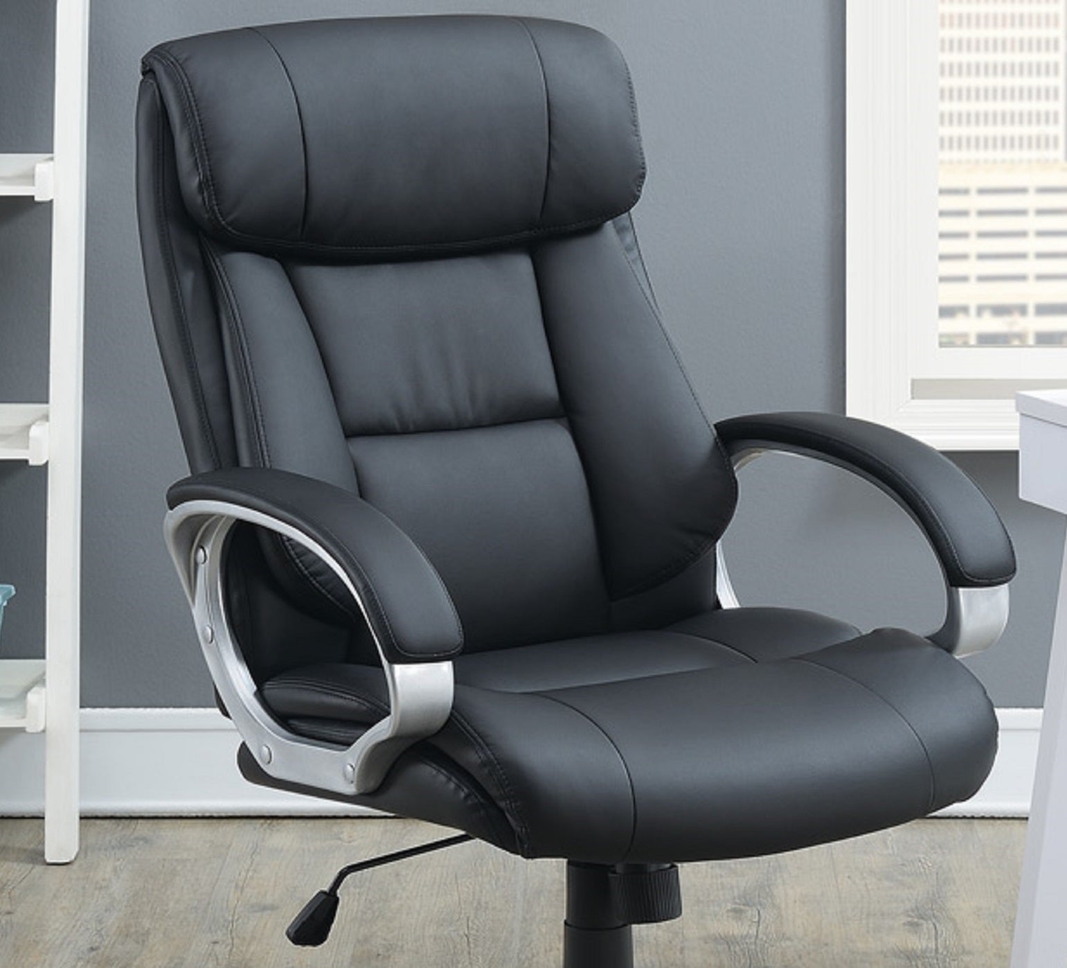 Black executive office chair with padded armrests and lumbar support