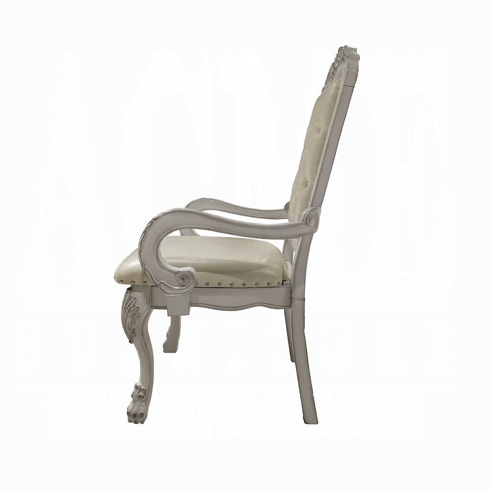Elegant ivory upholstered armchair with ornate carved wooden legs and arms
