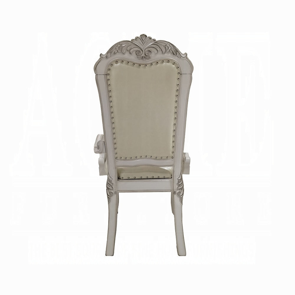 Elegant antique white carved wood armchair with upholstered cream seat and back