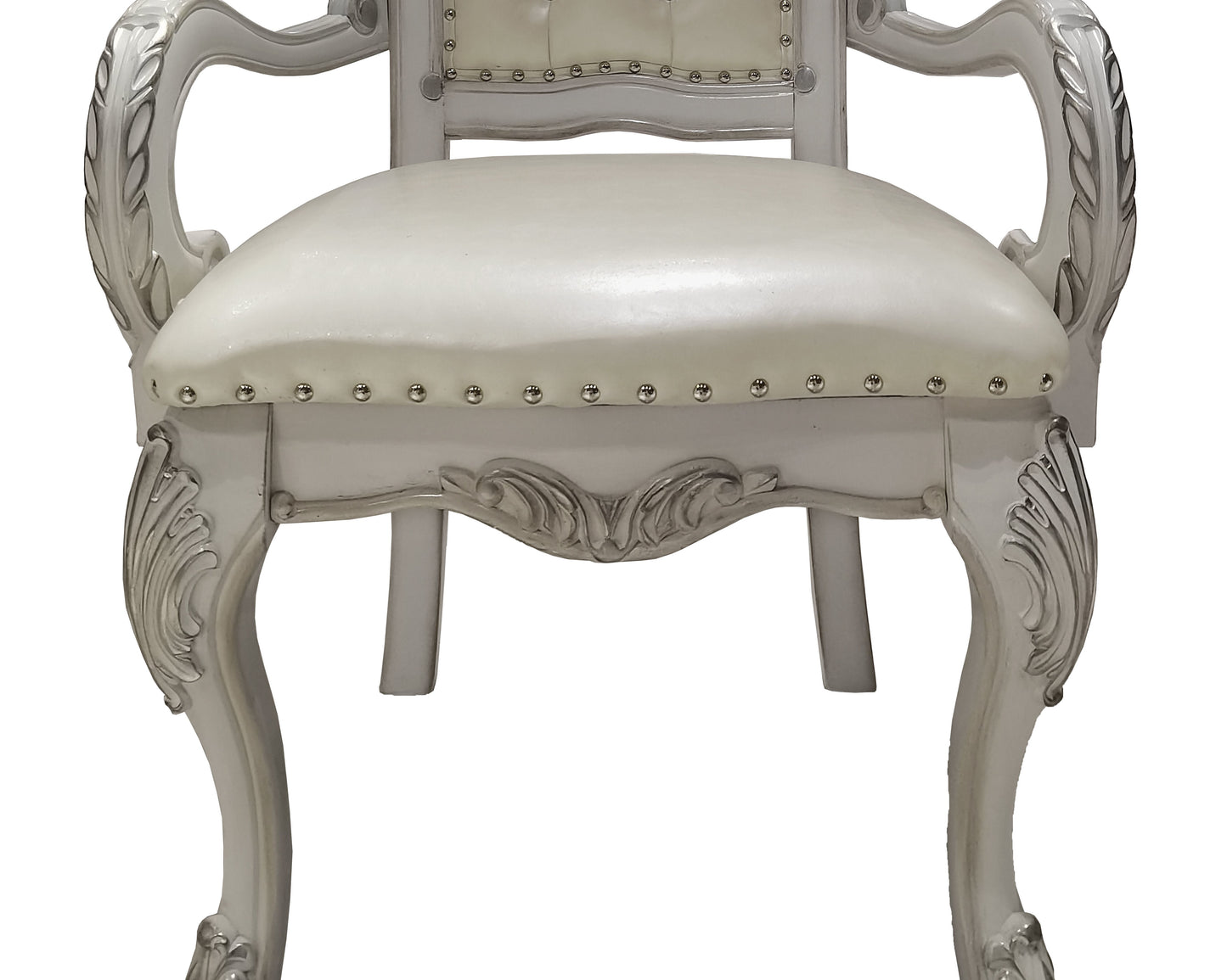 Elegant cream upholstered armchair with carved silver wood frame and decorative studs