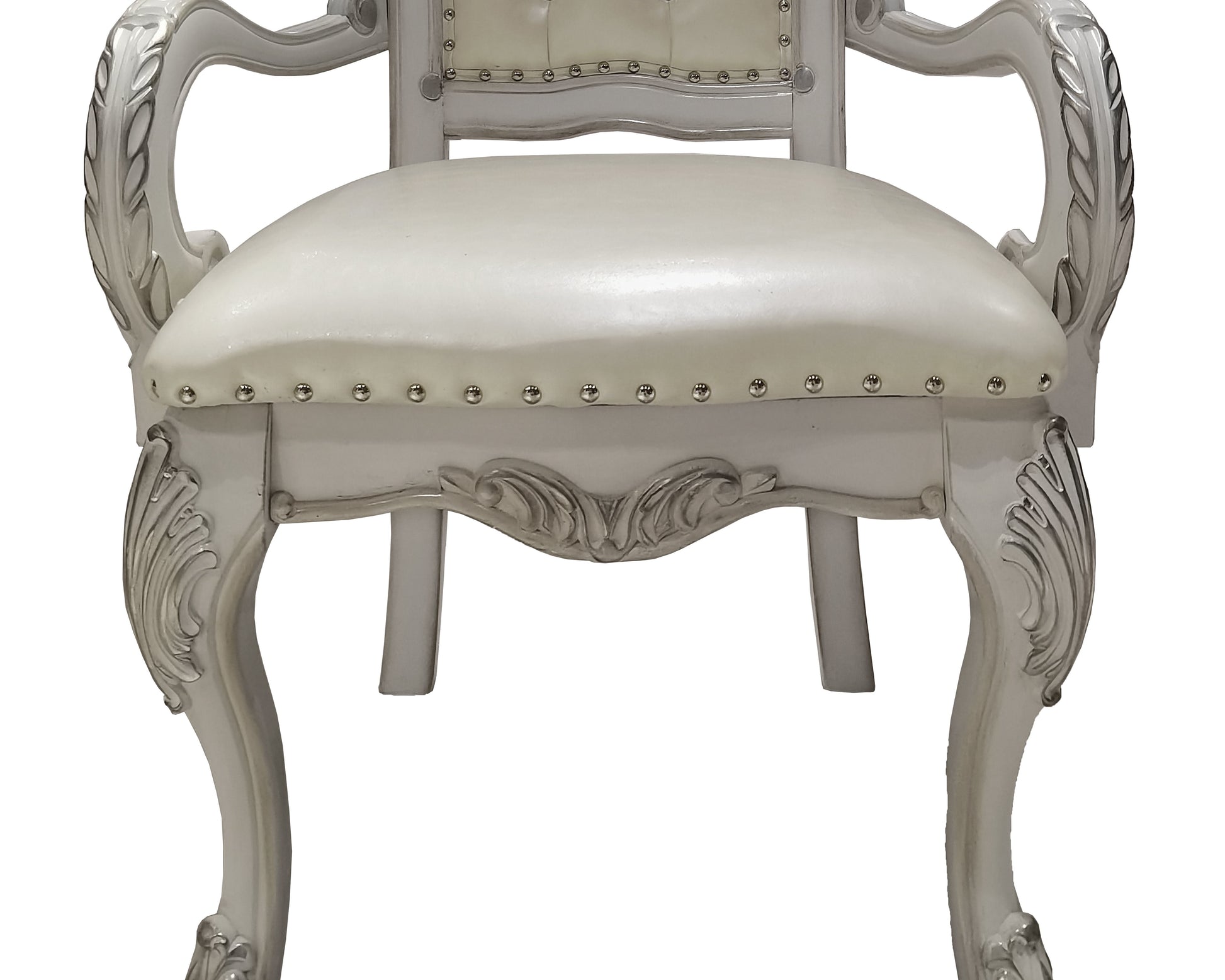 Elegant cream upholstered armchair with carved silver wood frame and decorative studs