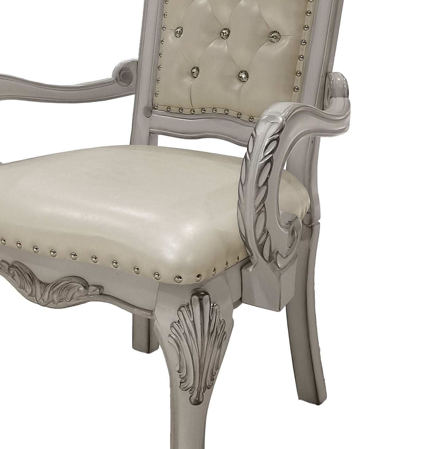 Ornate silver armchair with tufted cream upholstery and crystal accents