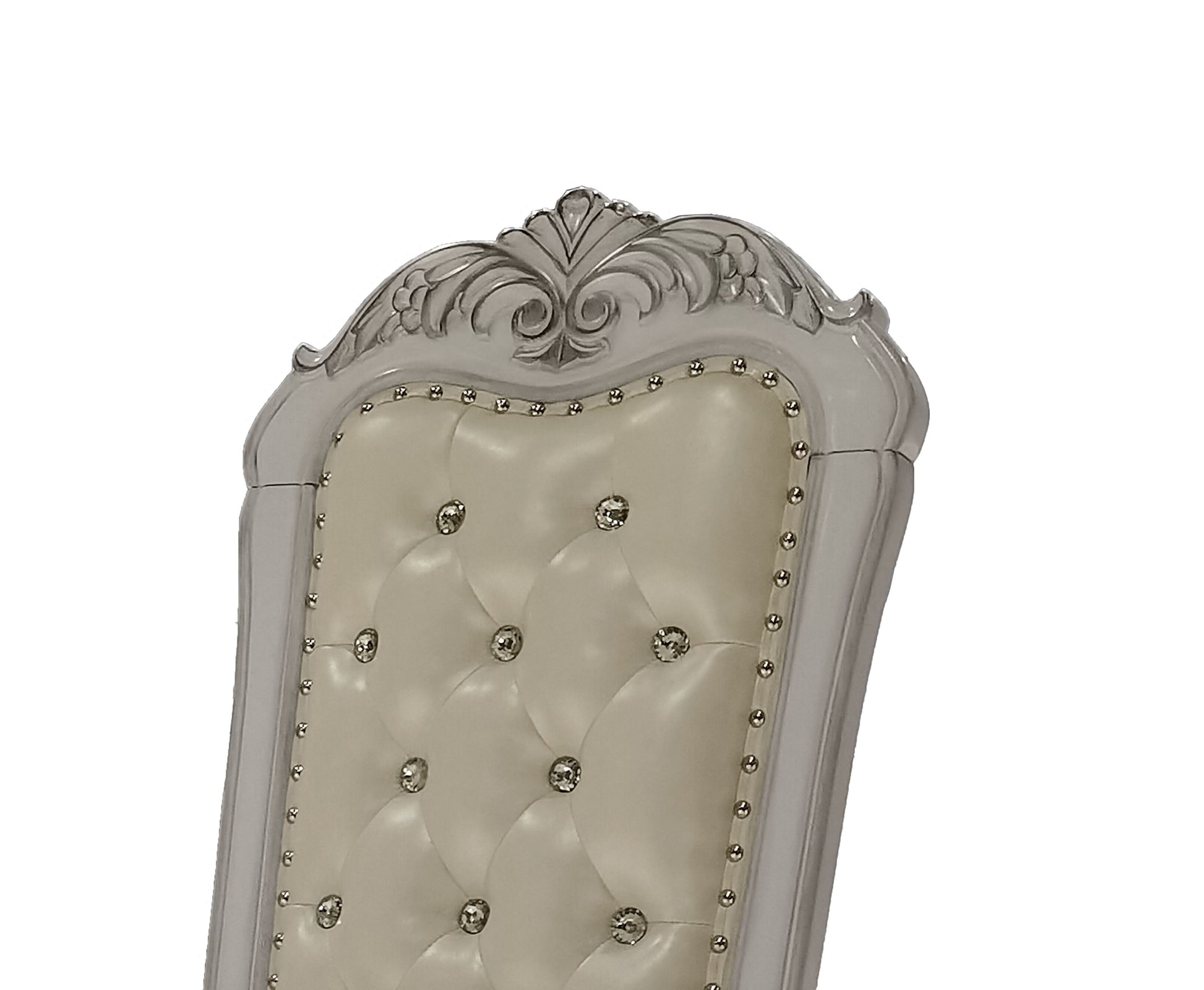 Cream upholstered tufted dining chair with rhinestone accents and carved silver wood trim