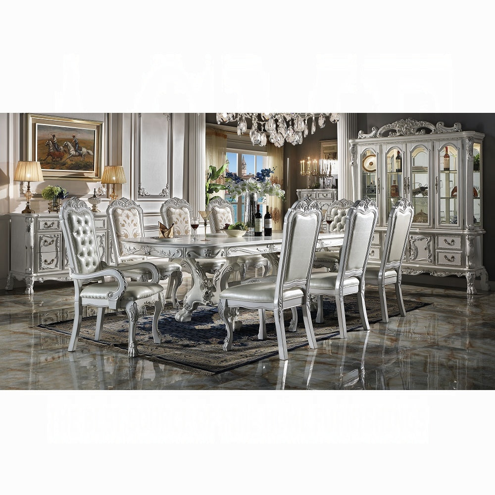 Ornate white dining table and chairs with silver accents perfect for formal dining rooms